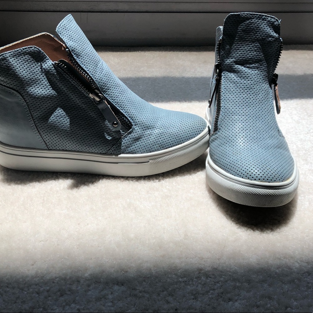 Blueish-grey high top sneakers.